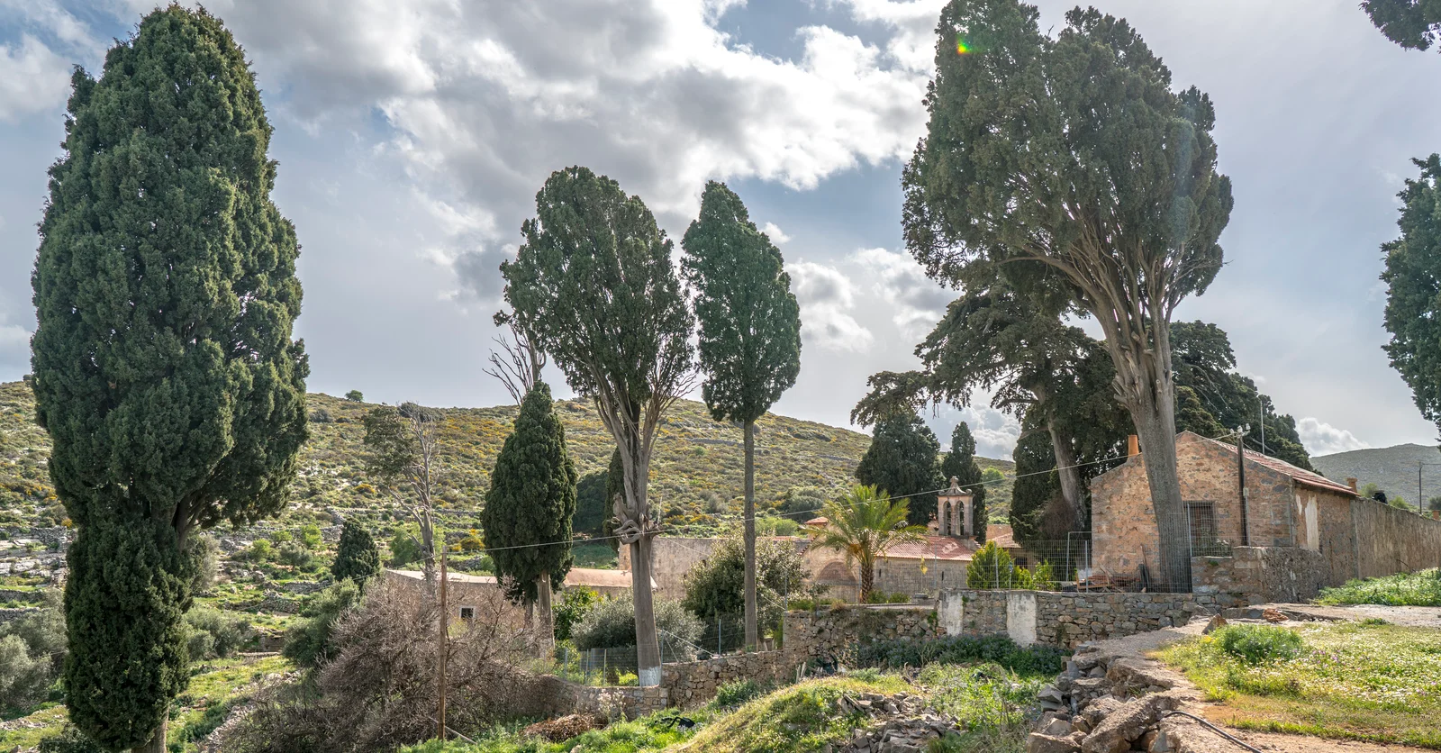 Moni Aretiou among cypress trees in the rocky Mirabello countryside.