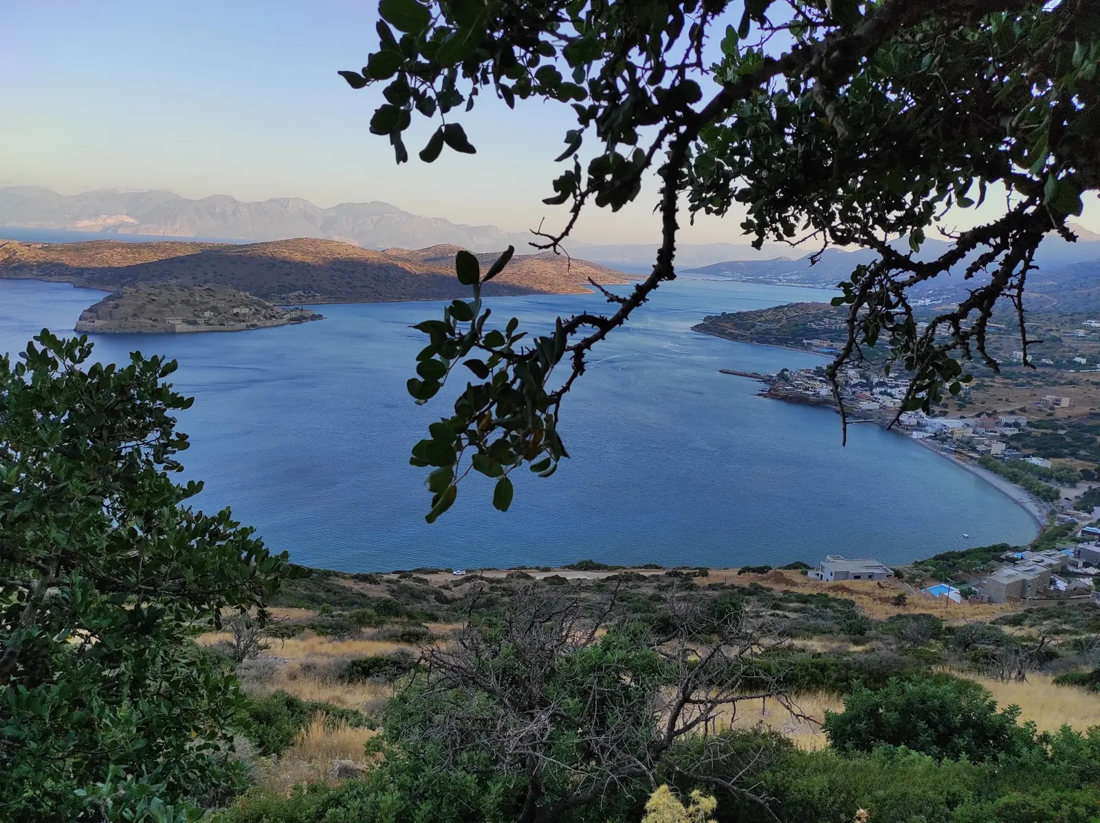 Spinalonga and the Gulf of Elounda seen from the hillside above the coast.
