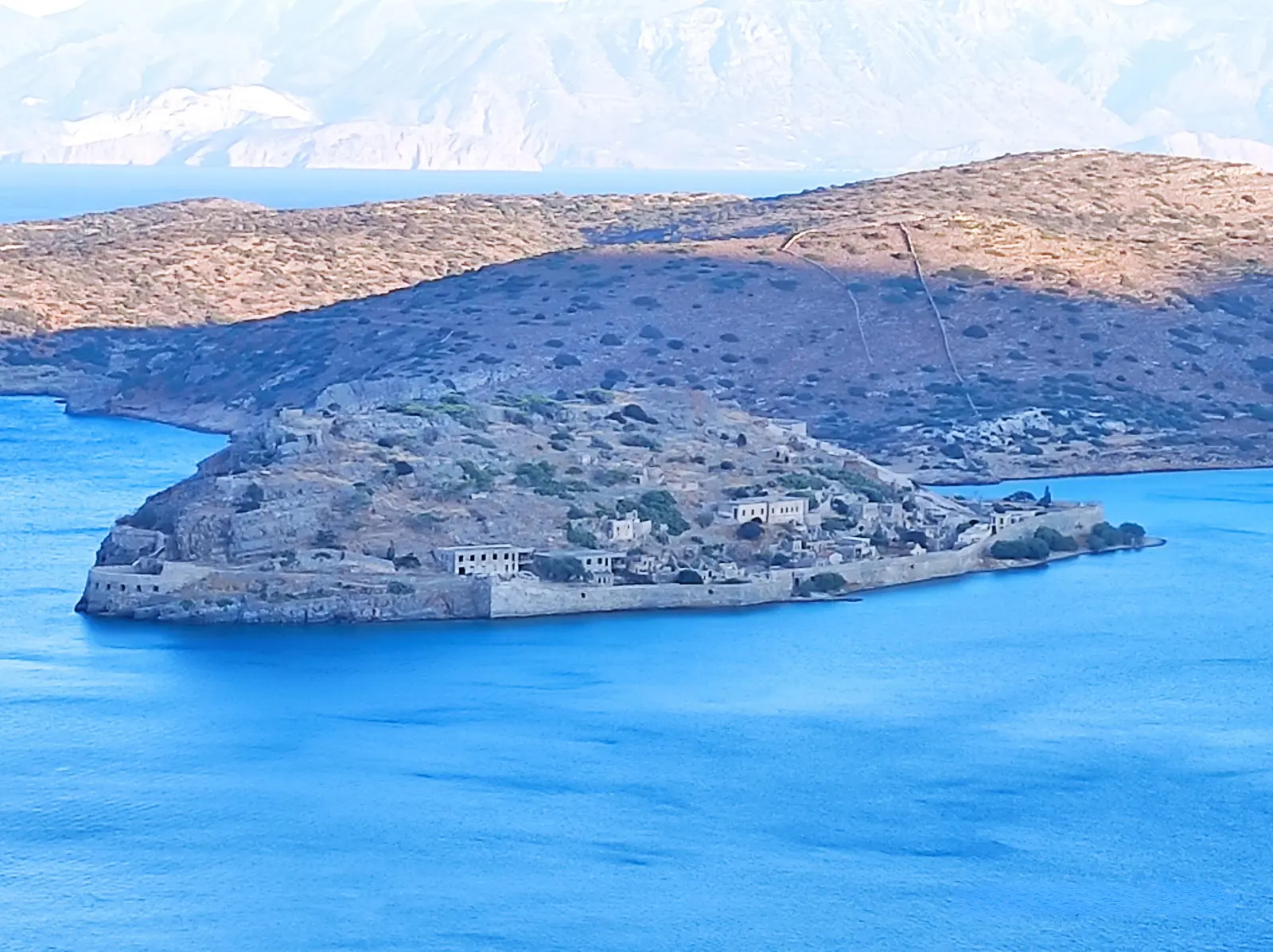 Closer view of Spinalonga’s fortifications and surviving settlement buildings.